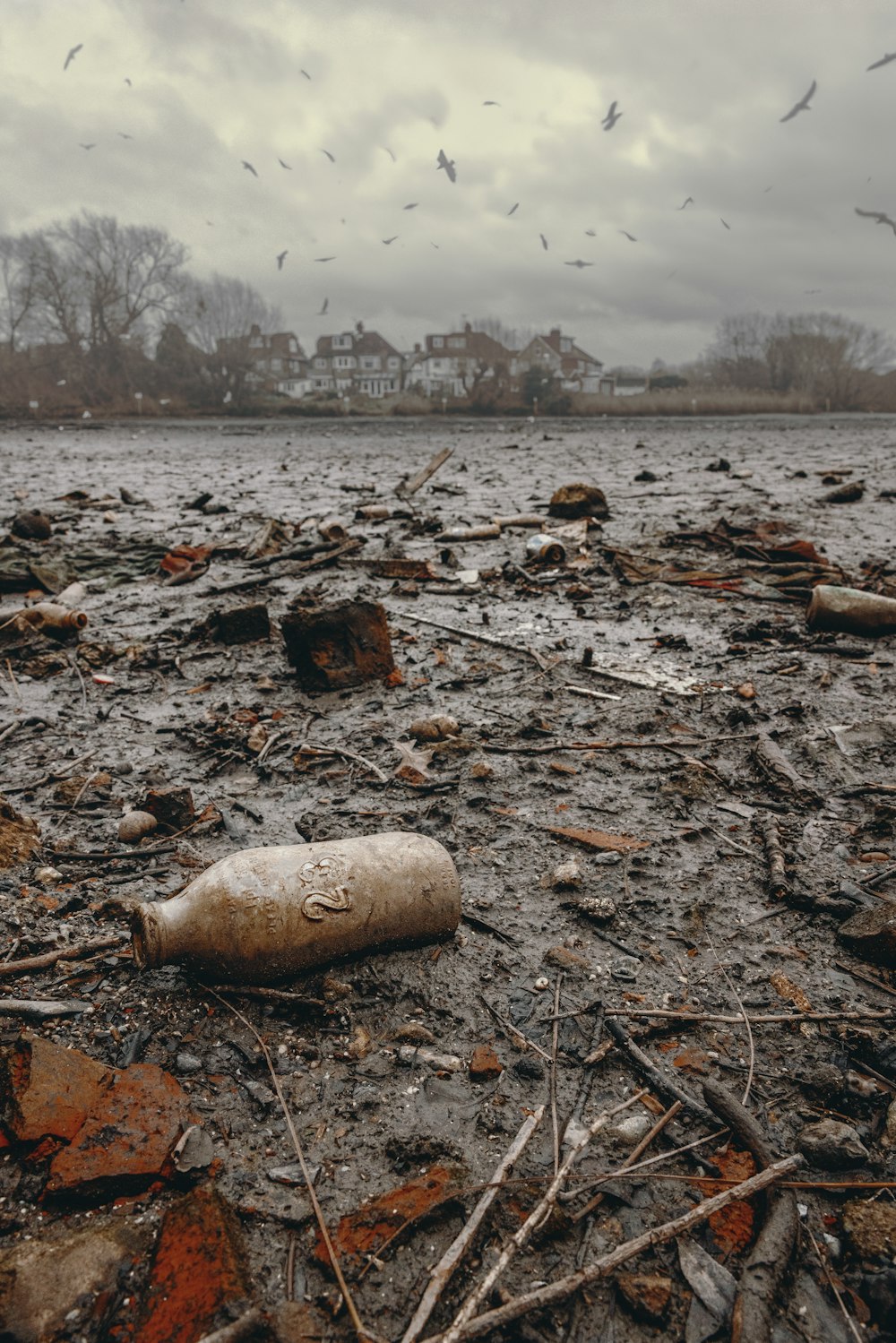 a bottle sitting on top of a sandy beach