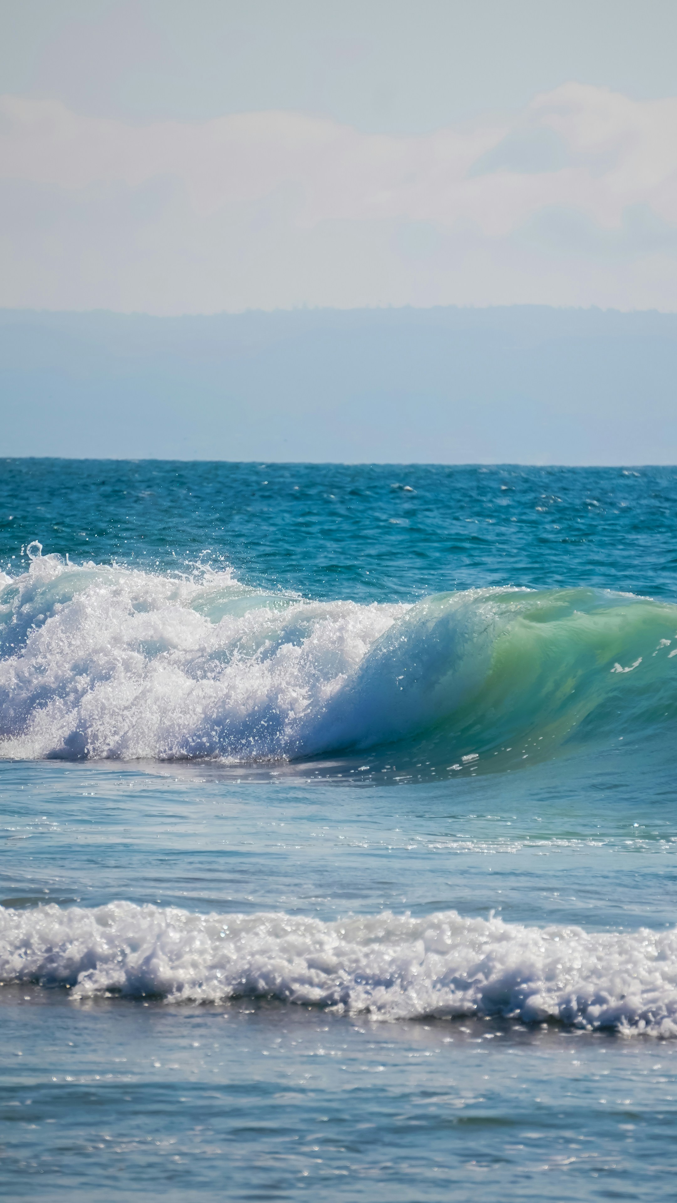 a person riding a wave on top of a surfboard