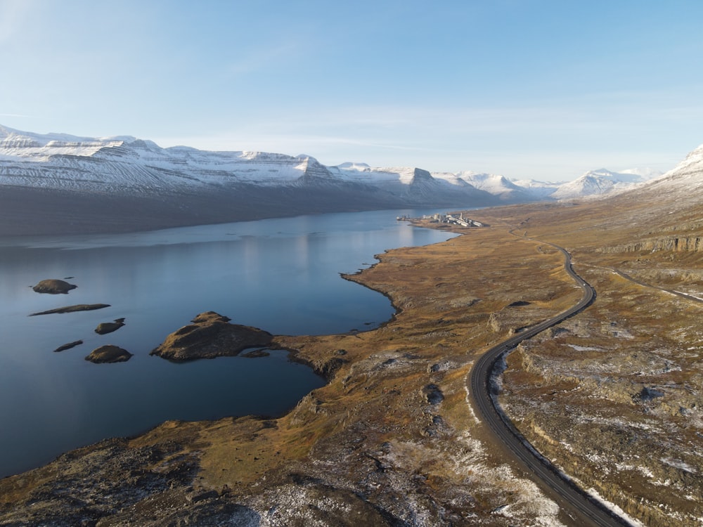 an aerial view of a road and a body of water