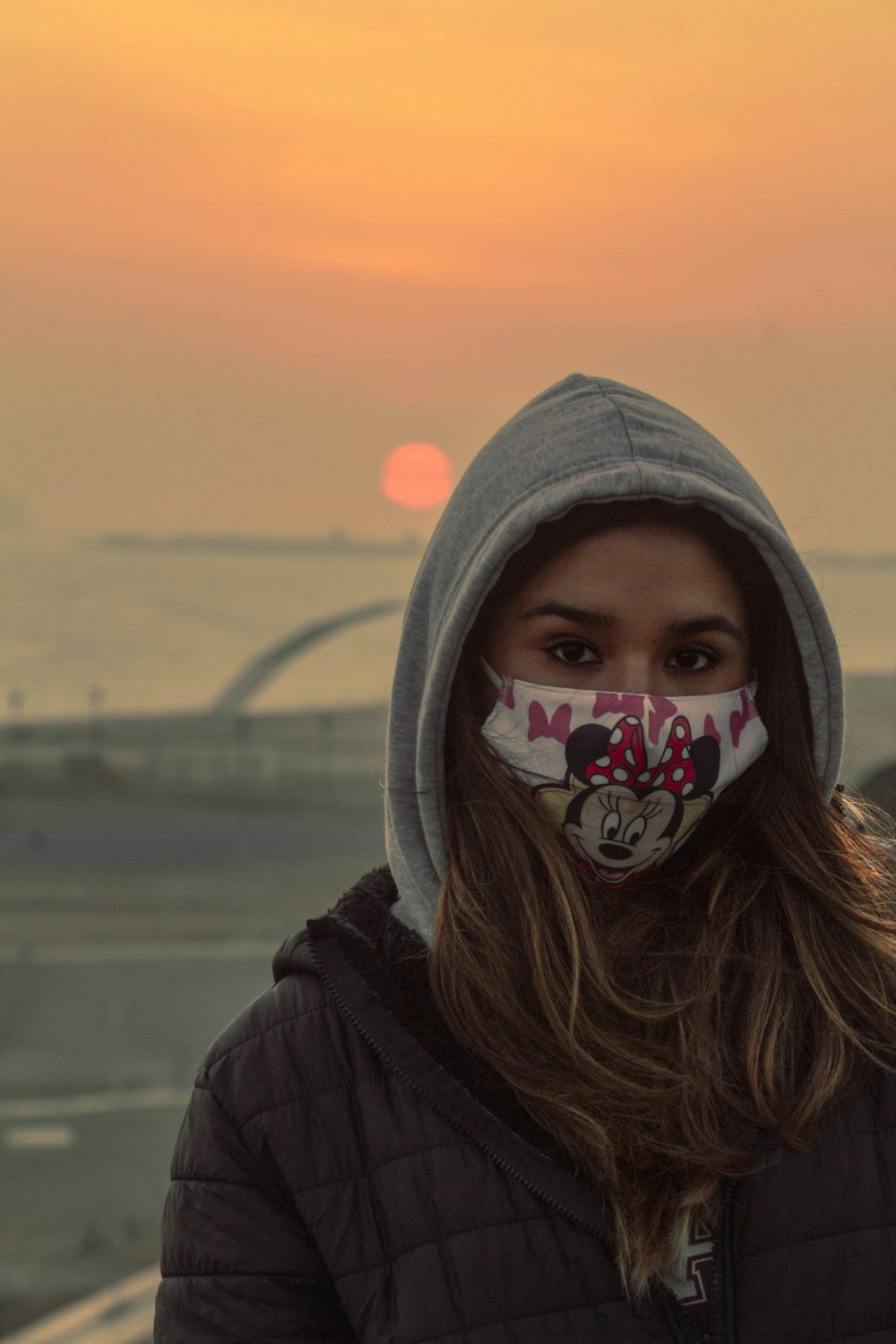 a woman wearing a mickey mouse face mask