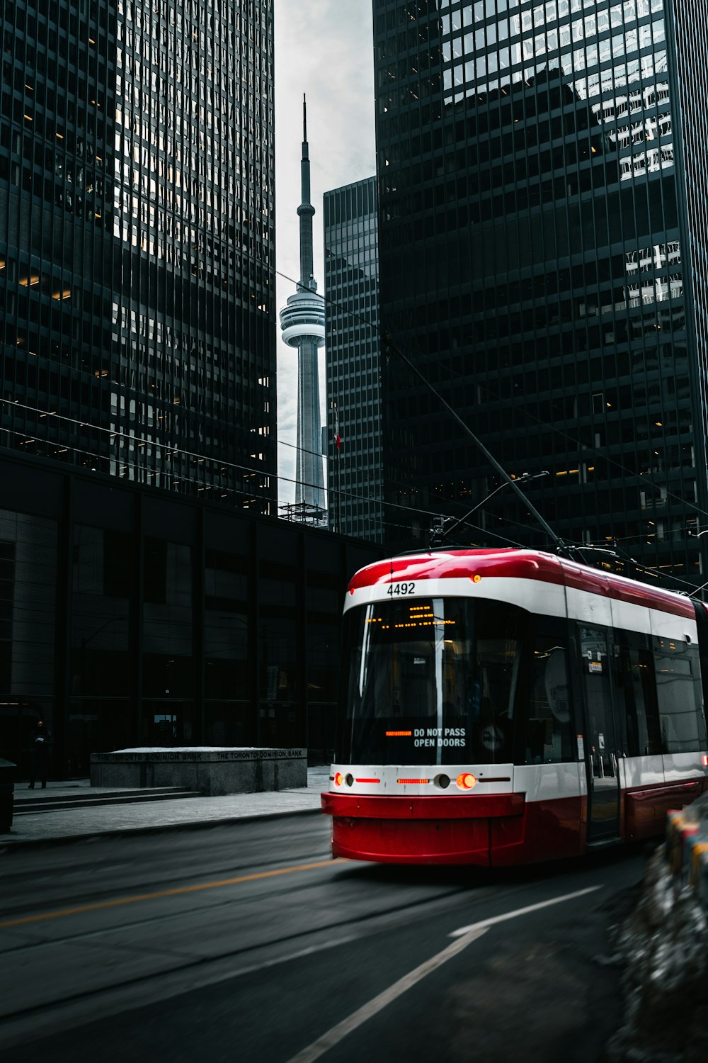 a red and white tram on a city street