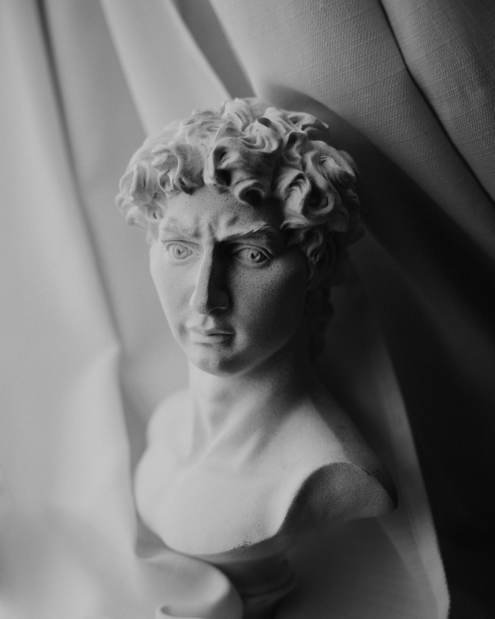 a black and white photo of a bust of a man