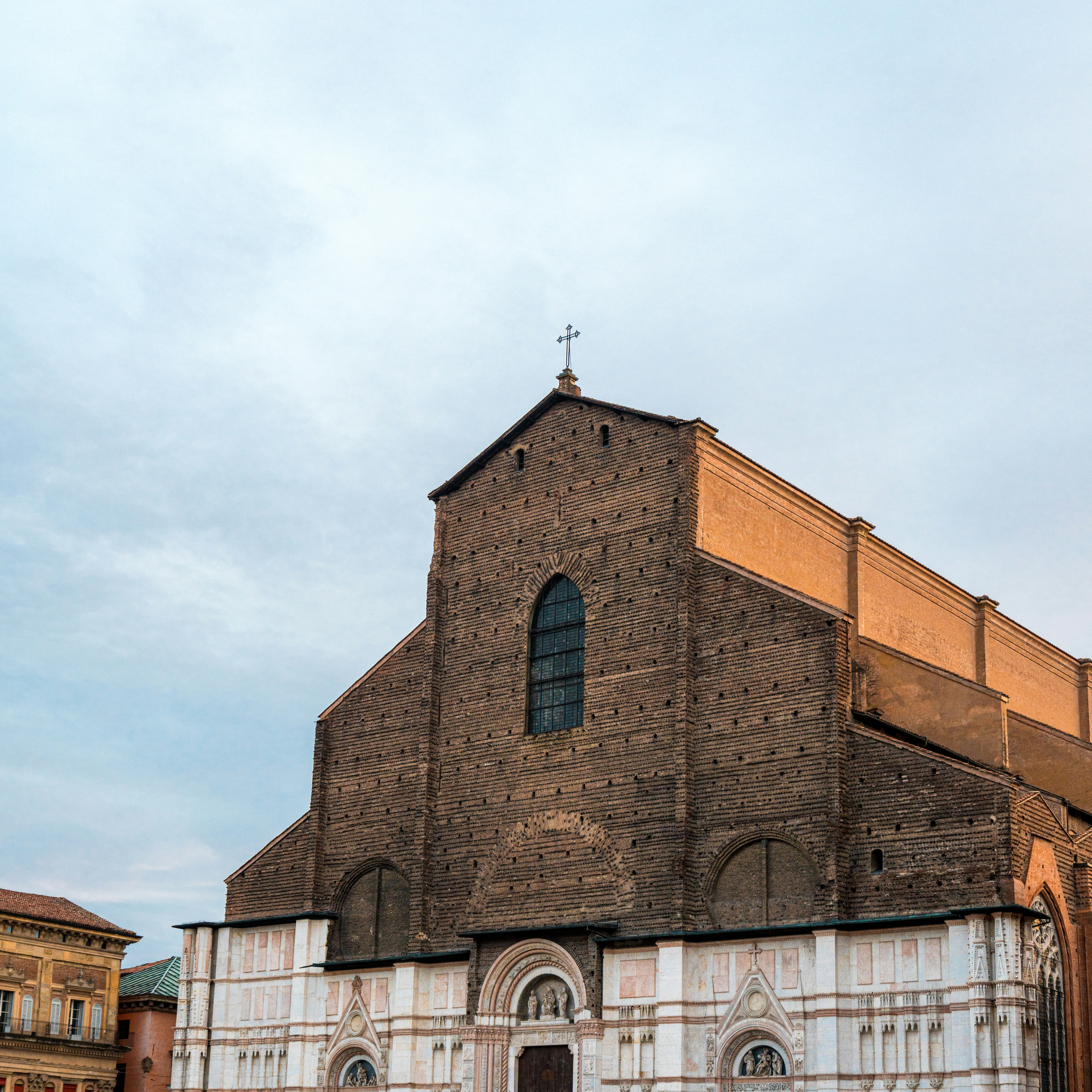 Bologna April — Basilica di San Petronio terracotta brick facade on a spring day