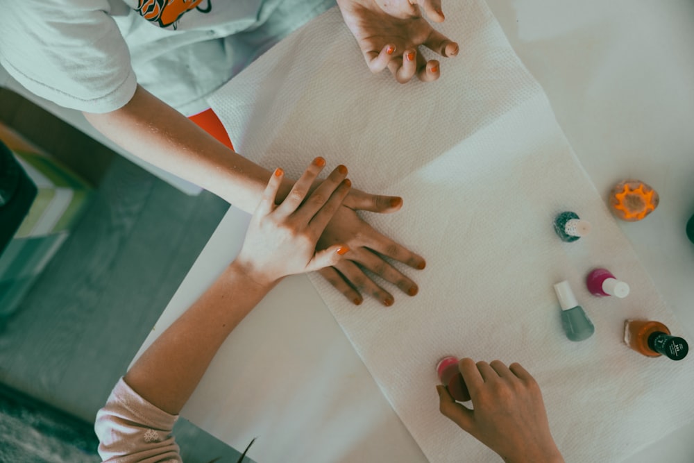 a group of people sitting at a table with their hands on a piece of paper