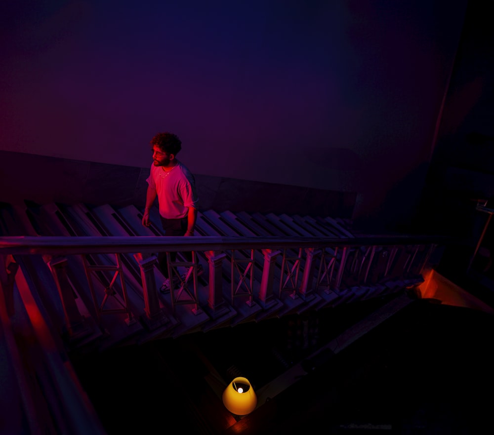 a person standing on a bridge in the dark