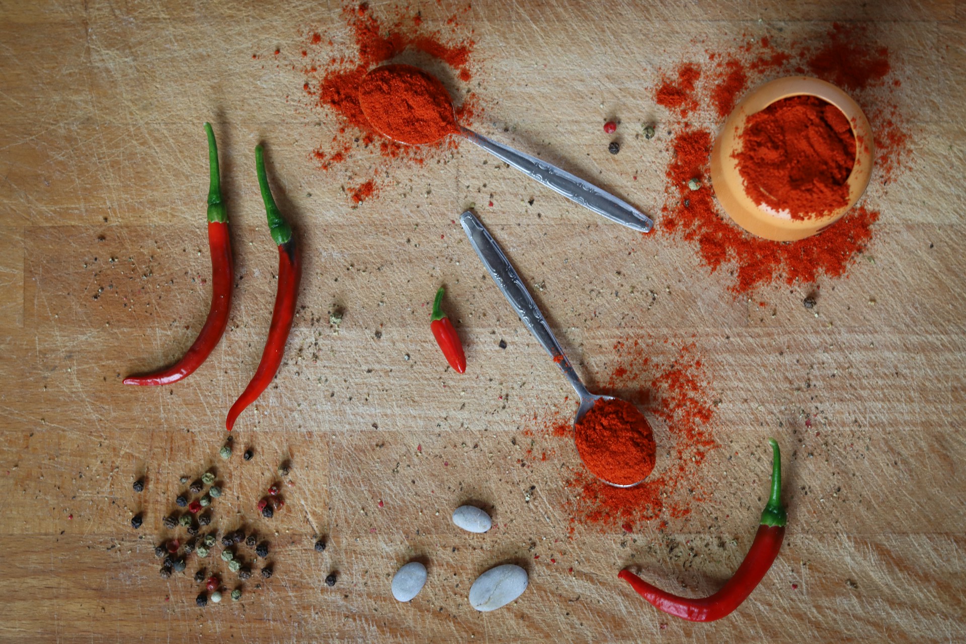a wooden table topped with different types of spices