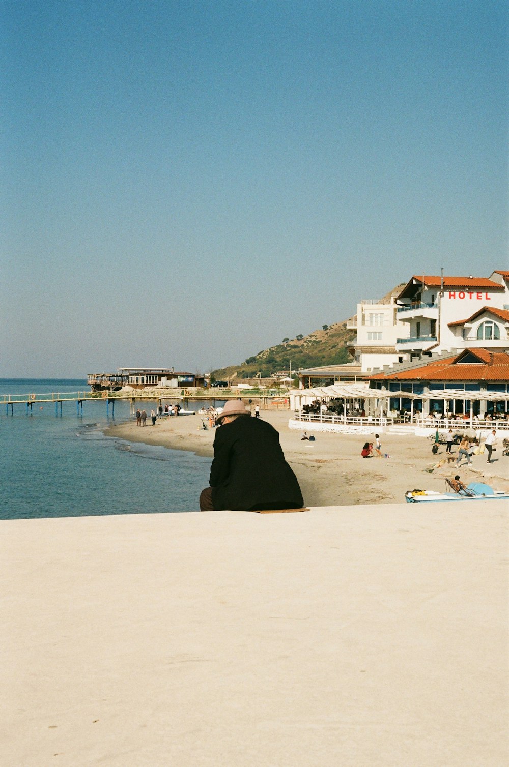 a person sitting on a beach looking out at the ocean