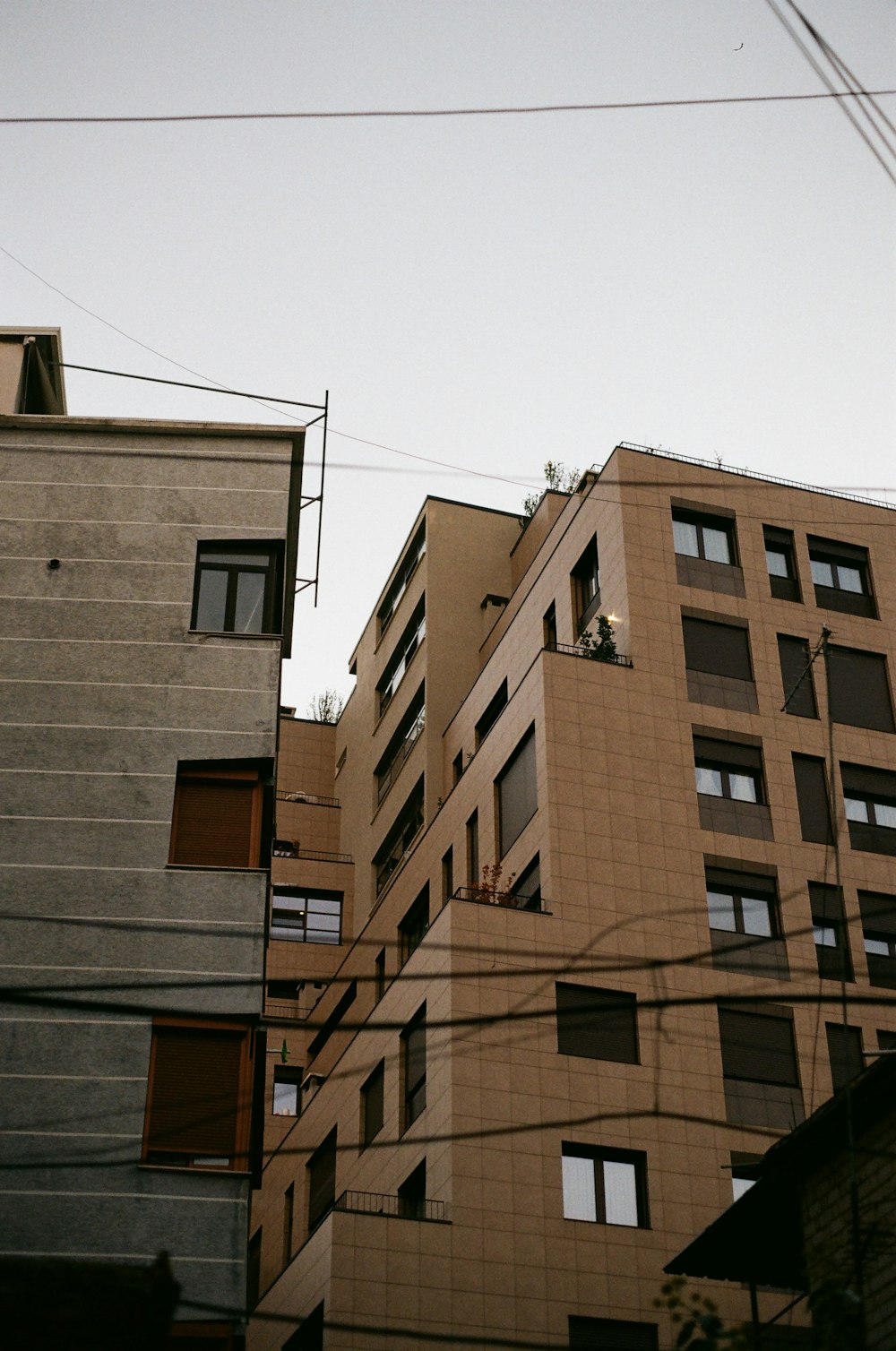 a tall building with lots of windows next to other buildings