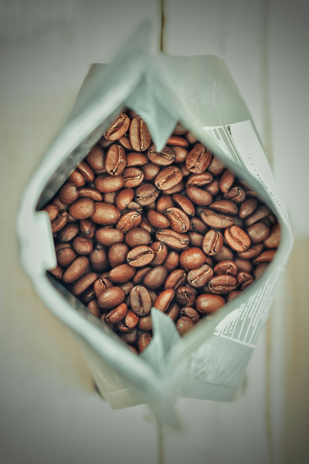 a bag full of coffee beans sitting on a table