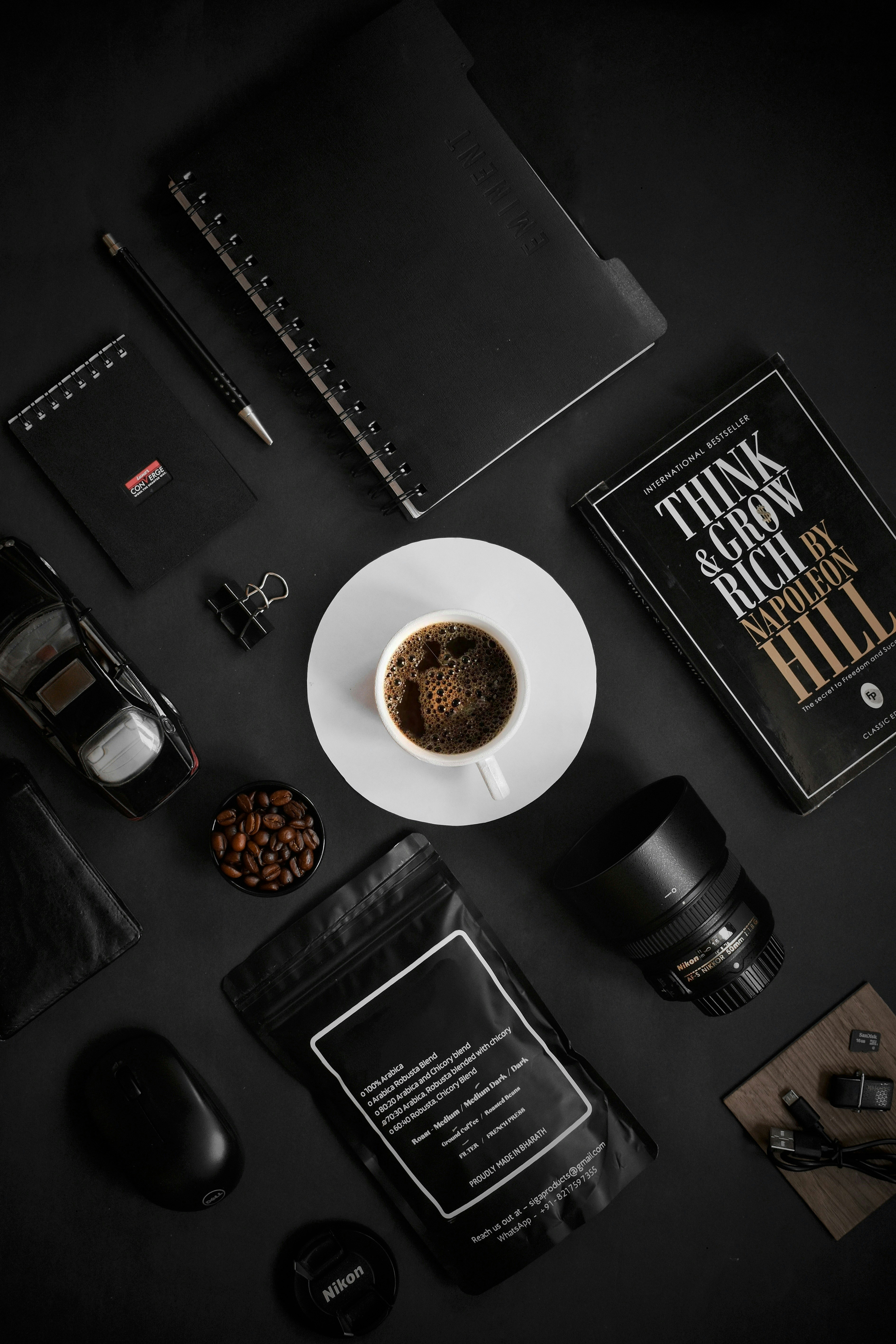 a cup of coffee sitting on top of a white plate