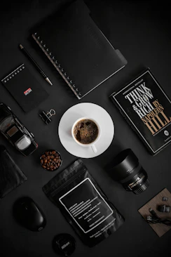 a cup of coffee sitting on top of a white plate