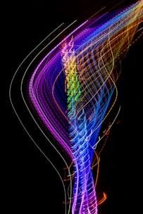 a long exposure photo of colorful lights in the dark