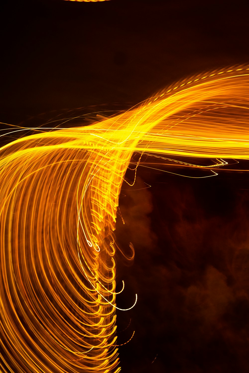 a long exposure photo of a yellow light