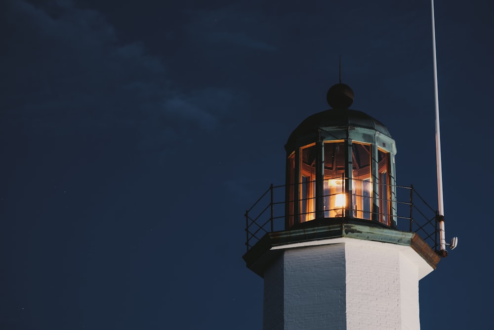 a light house with a flag on top of it