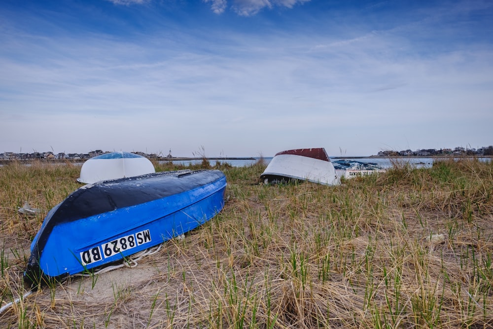 a couple of boats that are sitting in the sand