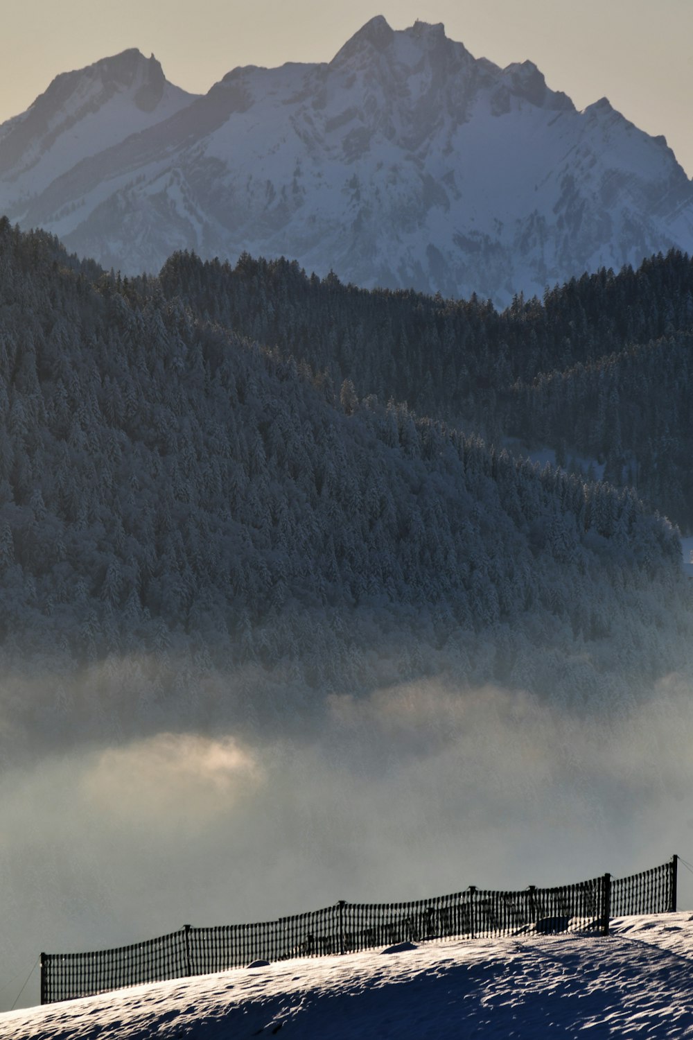 a person riding a snowboard on top of a snow covered slope