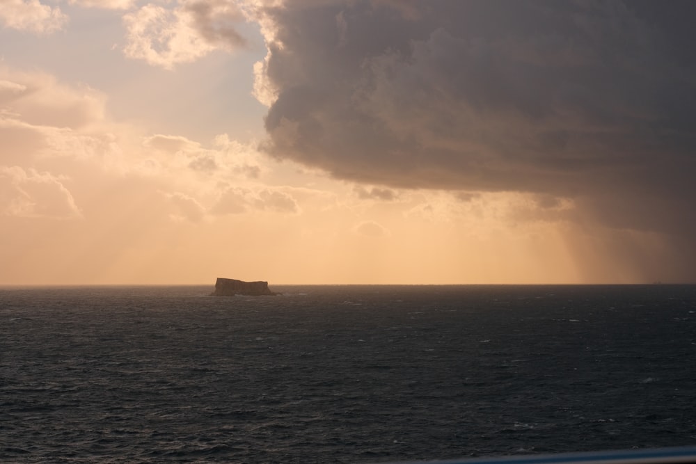 a large body of water under a cloudy sky