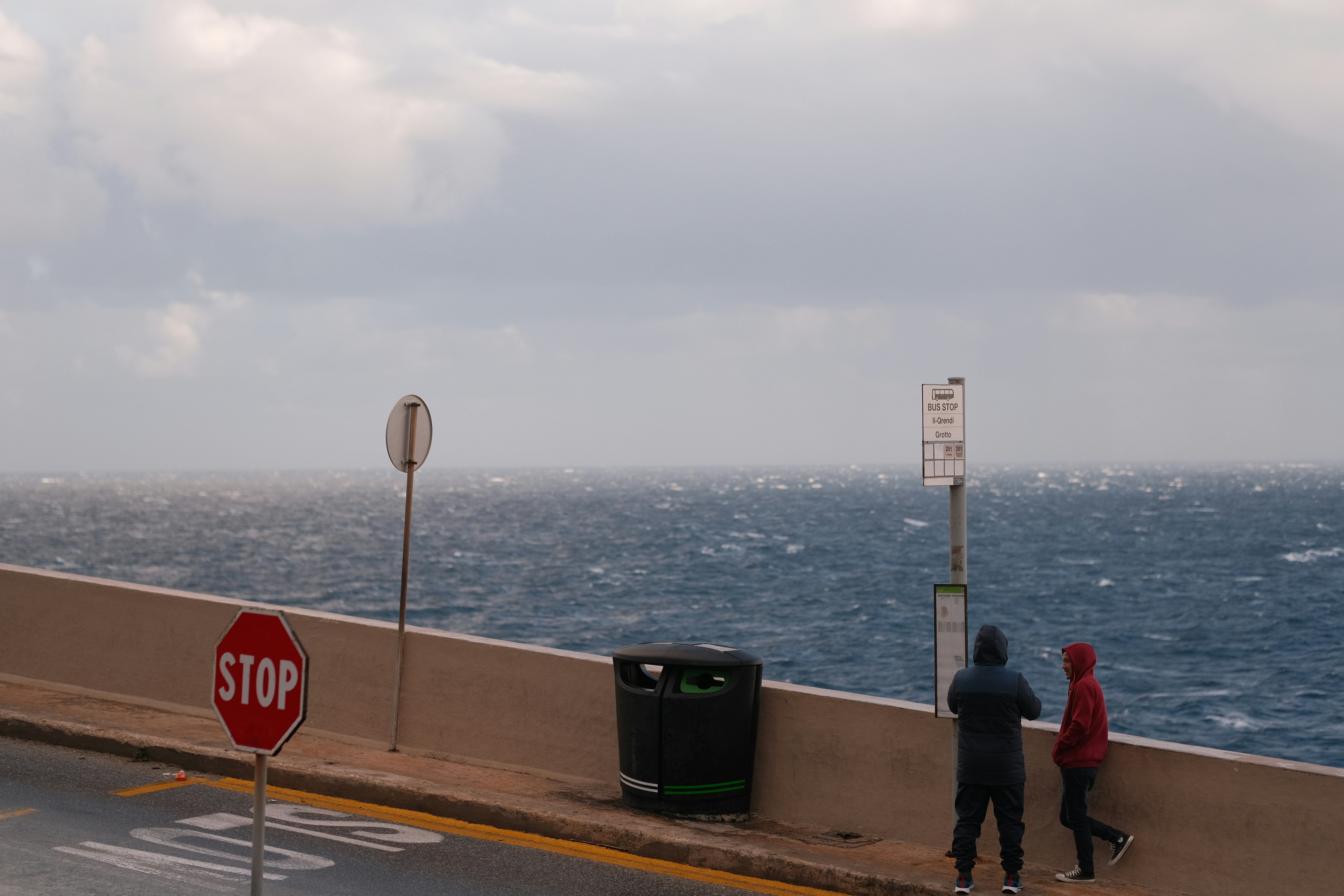 Person safely taking photos of a damaged dock from a distance, documenting storm damage - storm damage marine repair