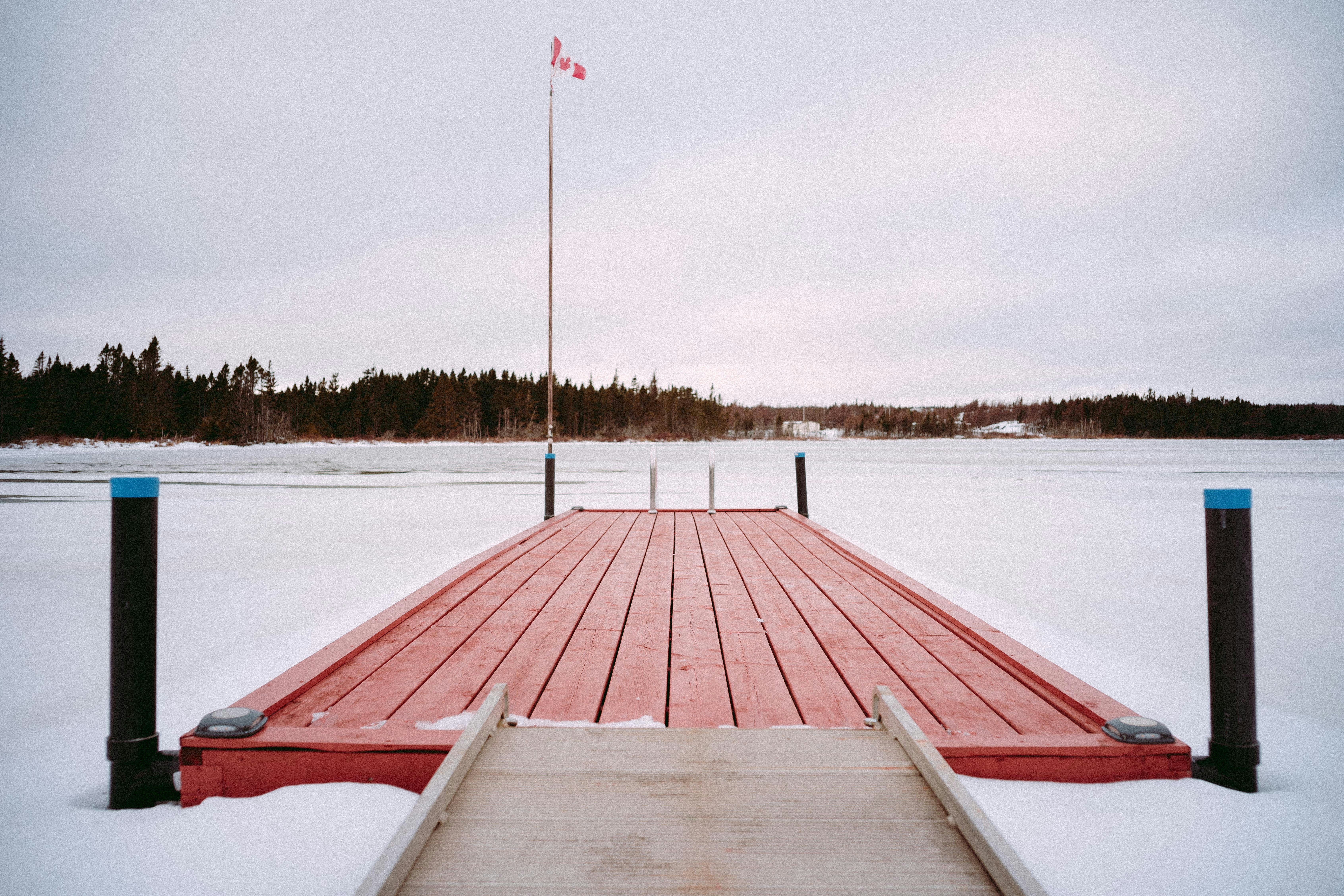 a wooden dock with a flag on top of it