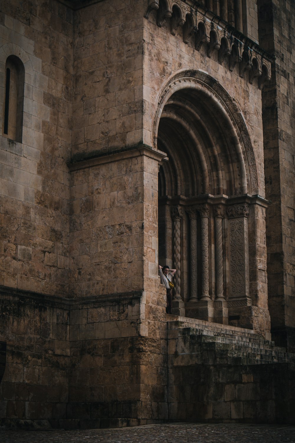 an old building with a stone wall and arched doorway