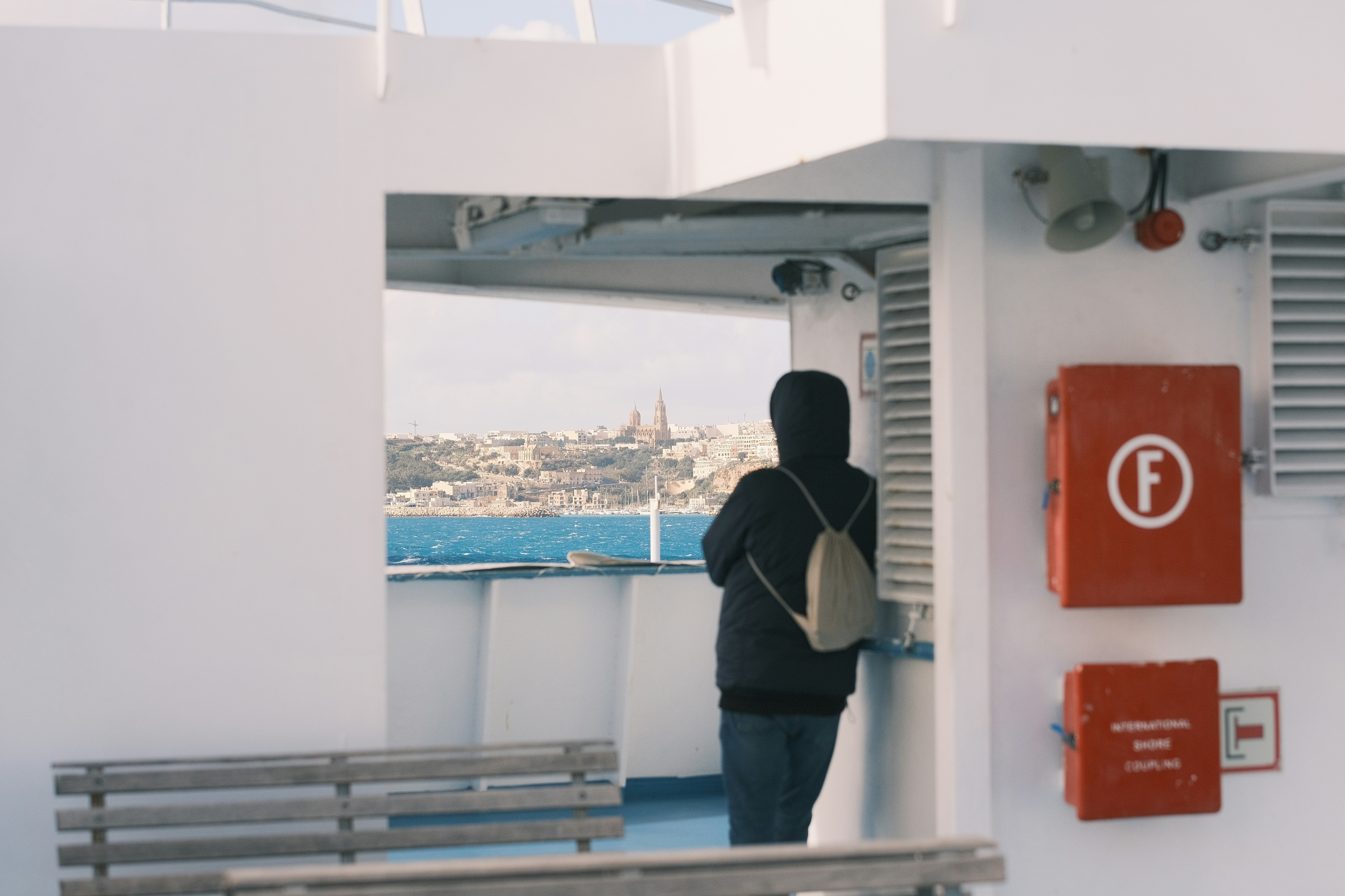 a person standing on a boat looking out at the water