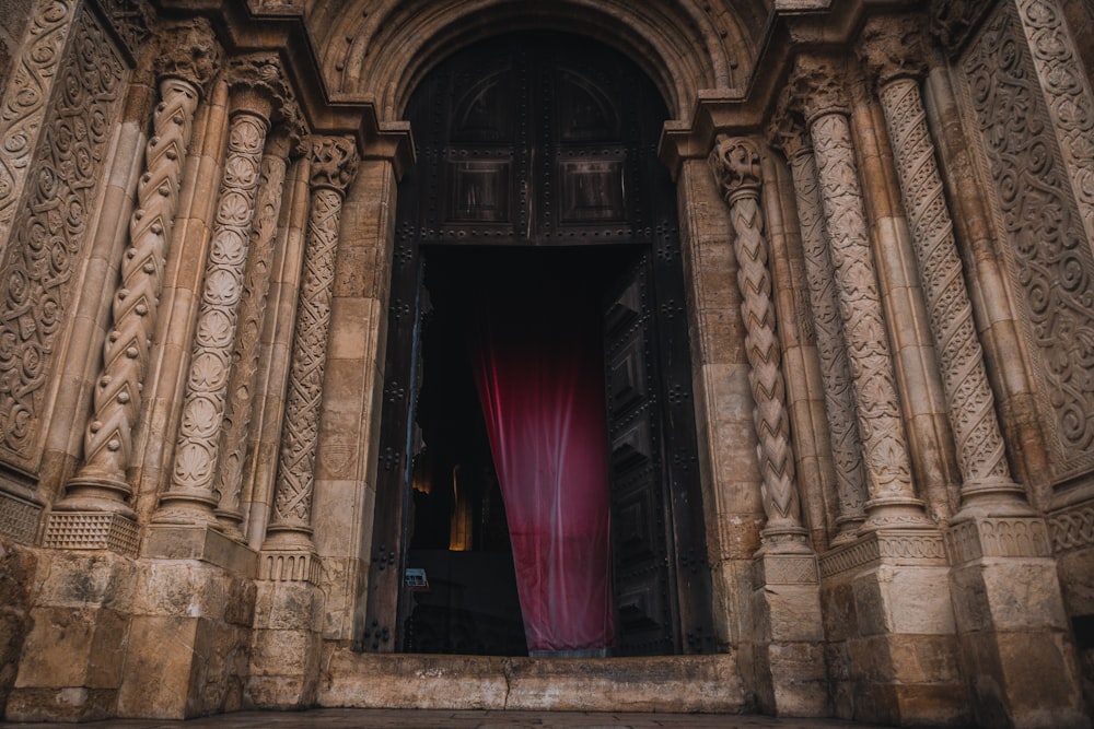 a large building with a red curtain in the doorway