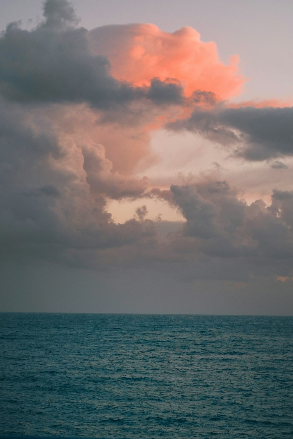 a large body of water under a cloudy sky