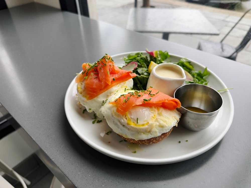 a white plate topped with eggs and salmon