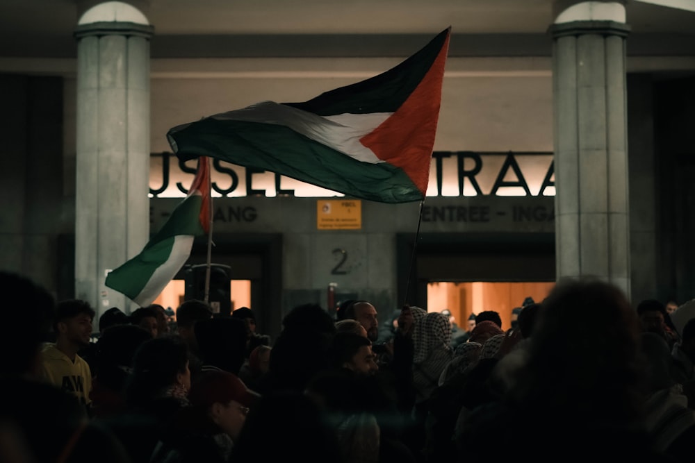 a crowd of people standing in front of a building