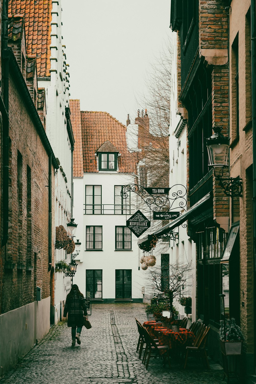 a person walking down a cobblestone street