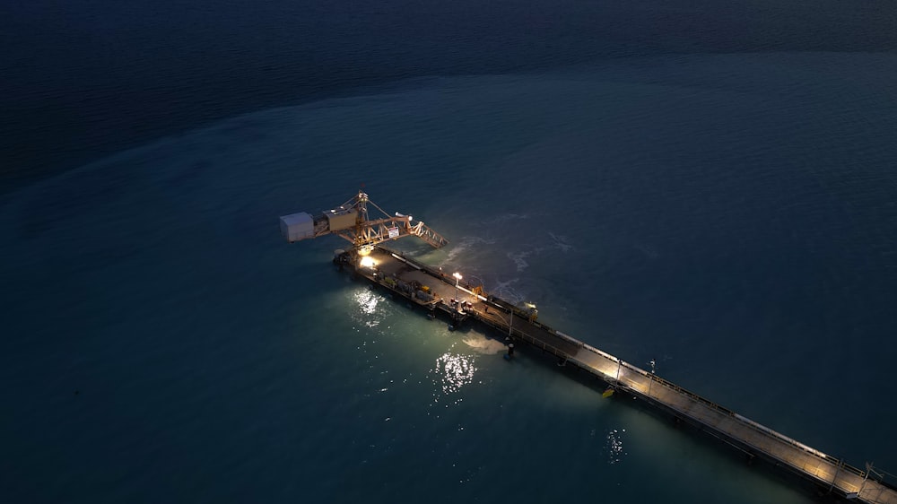 an aerial view of a pier at night