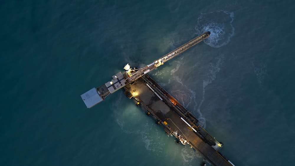 an aerial view of a pier in the middle of the ocean