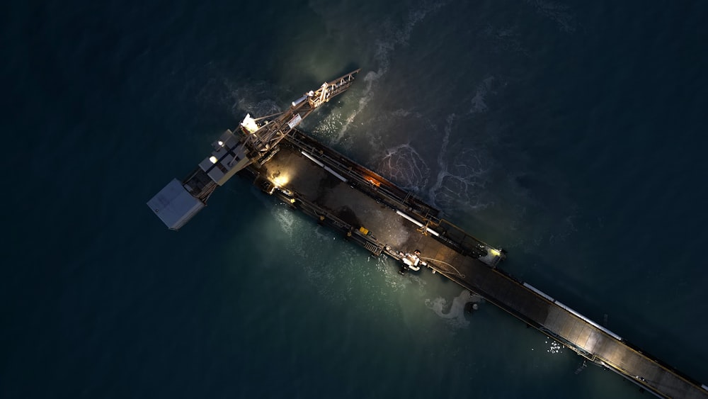 an aerial view of a pier at night