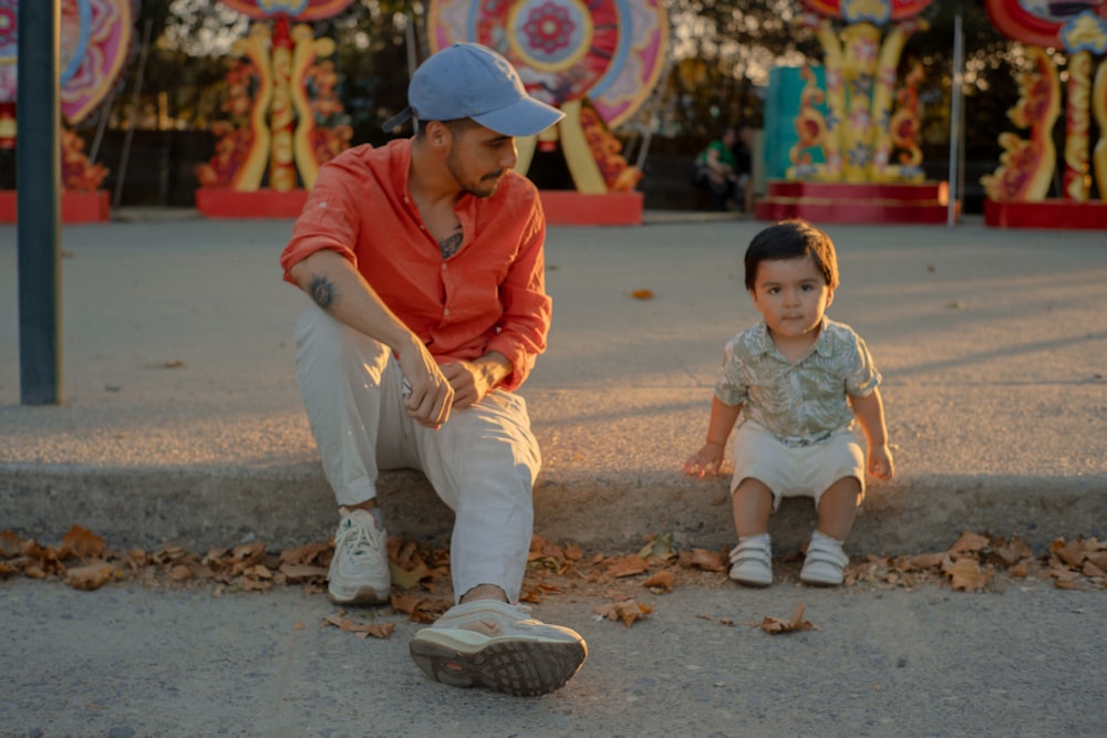 a man sitting next to a small child