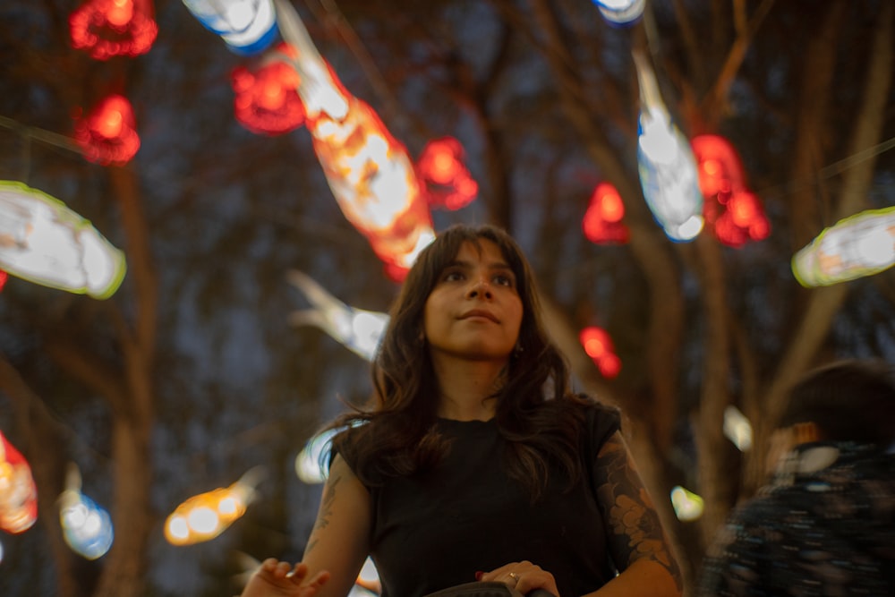 a woman standing in front of a bunch of lights