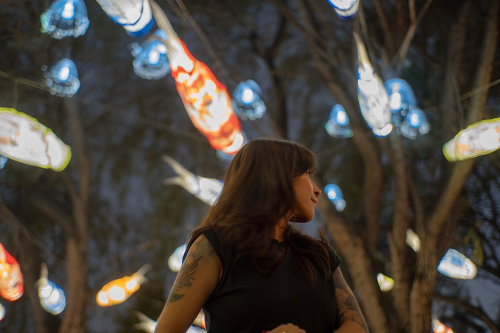 a woman standing in front of a bunch of lights