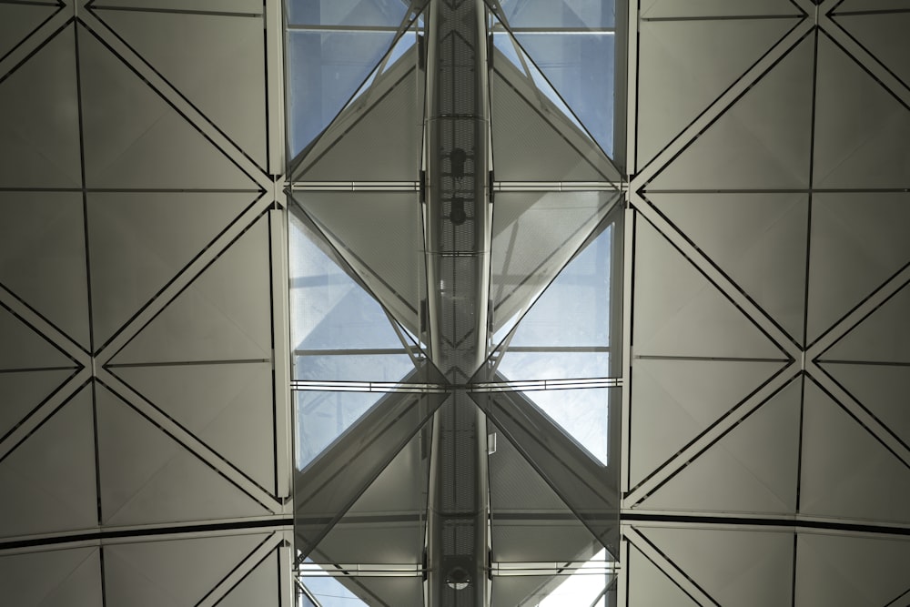 the ceiling of a building with a clock on it