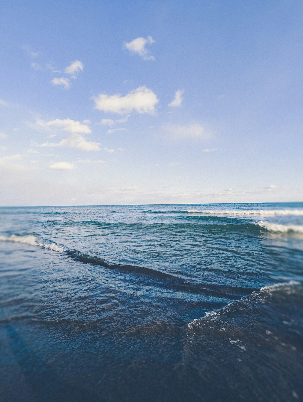 a body of water with waves coming in to shore