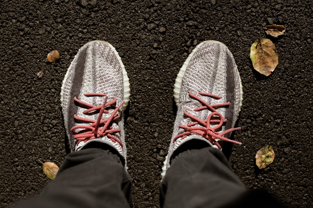 a person's feet with red laces on them