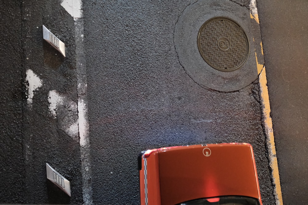 a red phone sitting on the side of a building