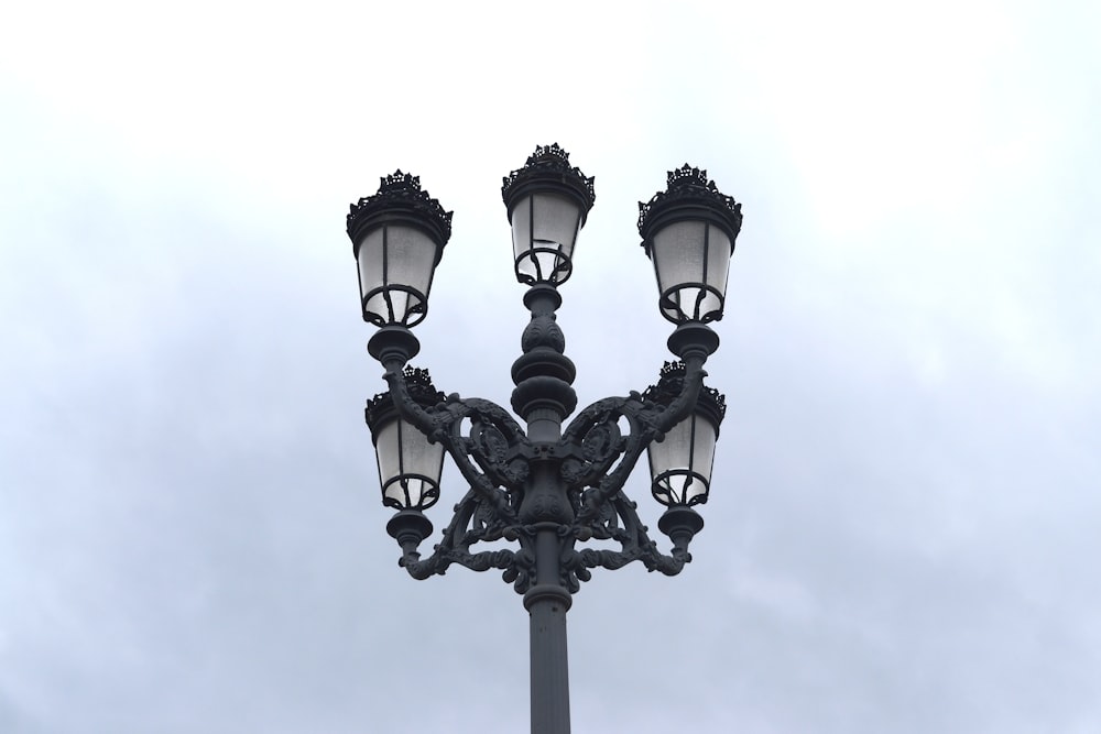 a lamp post with three lights on top of it