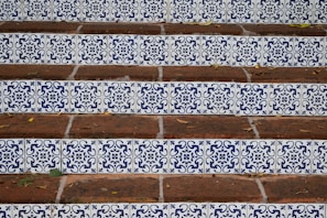 a close up of a set of steps with blue and white tiles