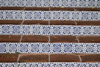 a close up of a set of steps with blue and white tiles