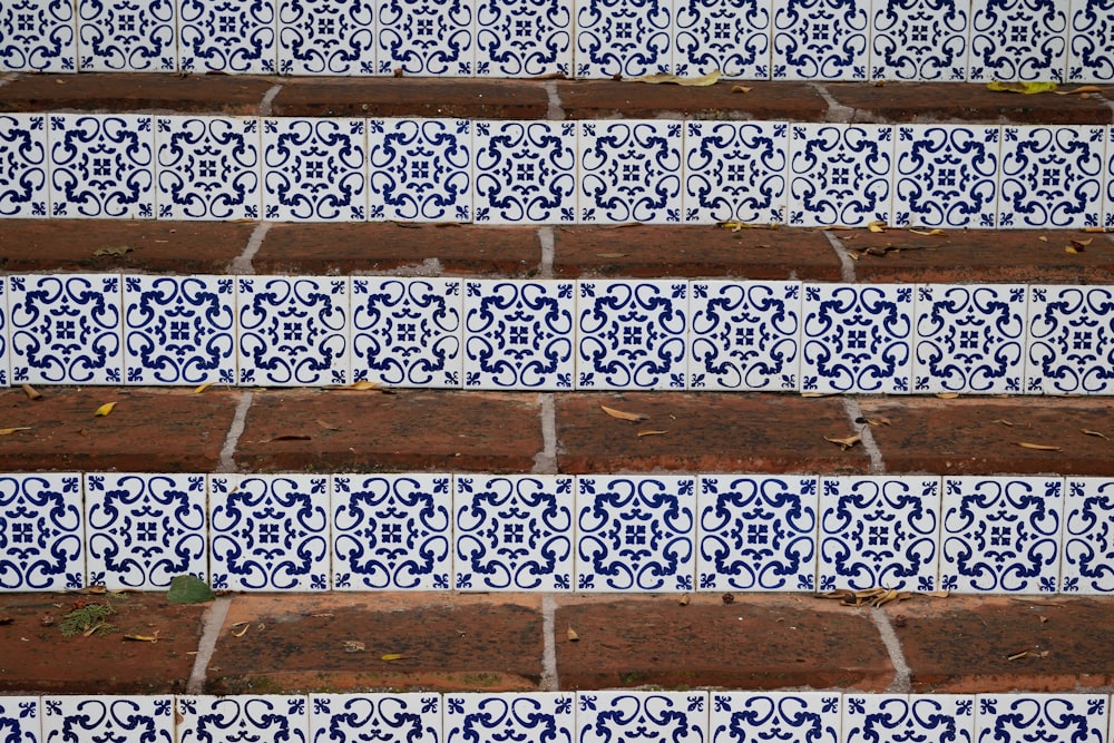 a close up of a set of steps with blue and white tiles