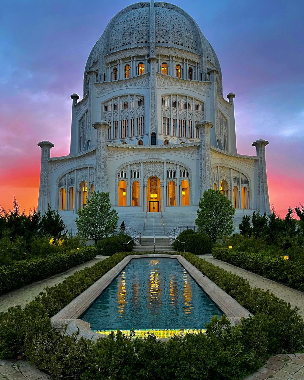 a large white building with a fountain in front of it