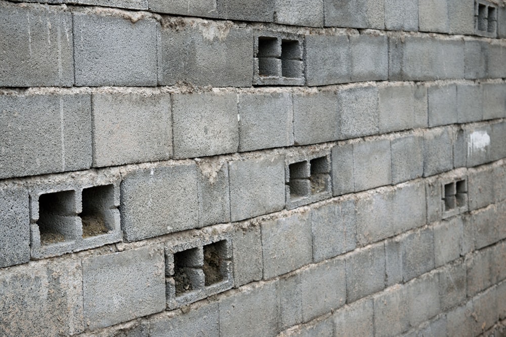 a close up of a brick wall with holes in it