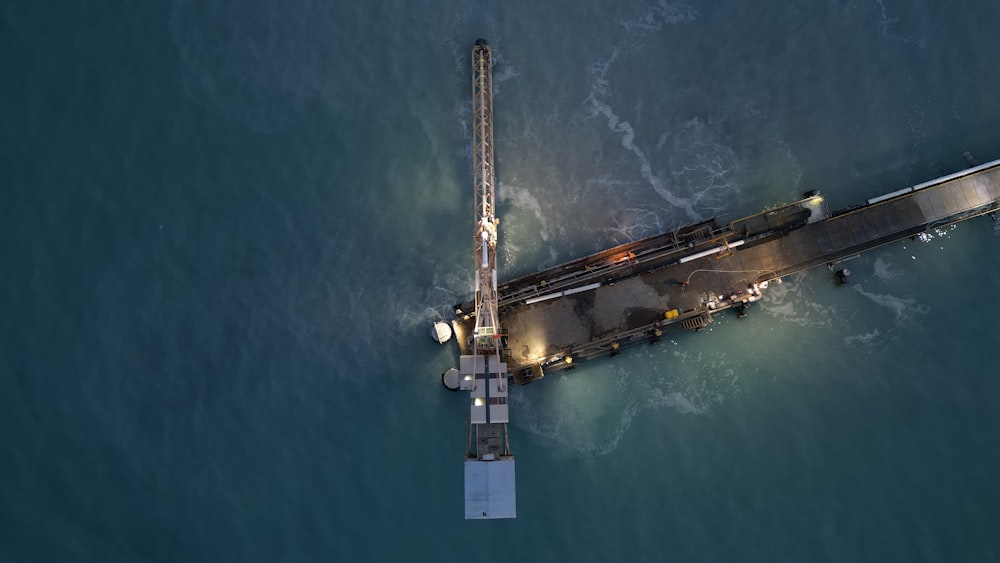 an aerial view of a pier in the middle of the ocean