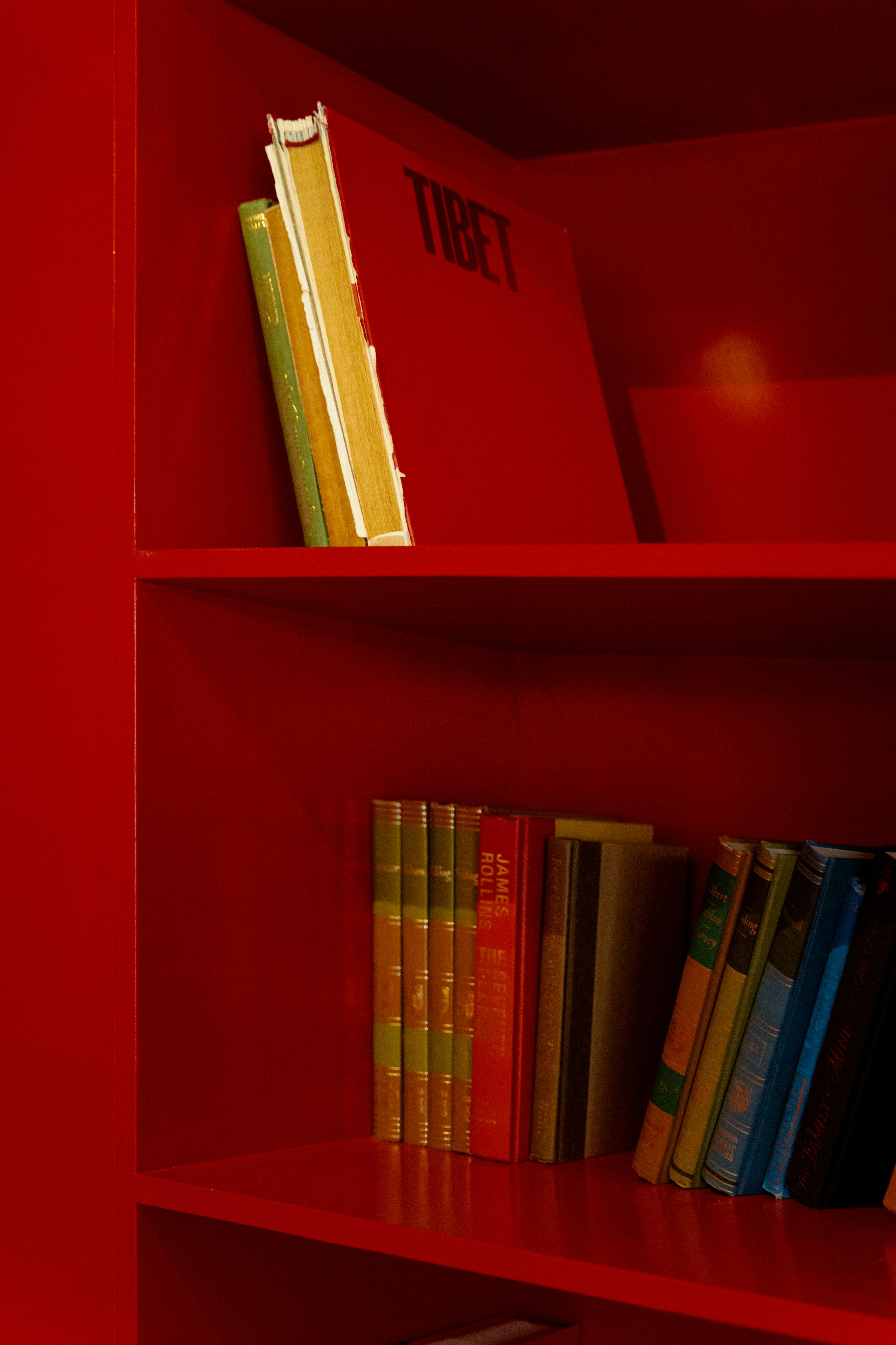 A red book shelf filled with lots of books photo Free Shelf Image on