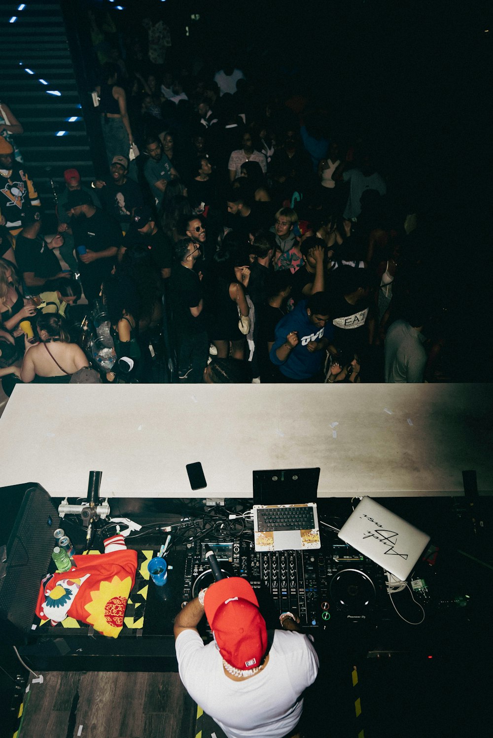 a dj mixing music in front of a crowd