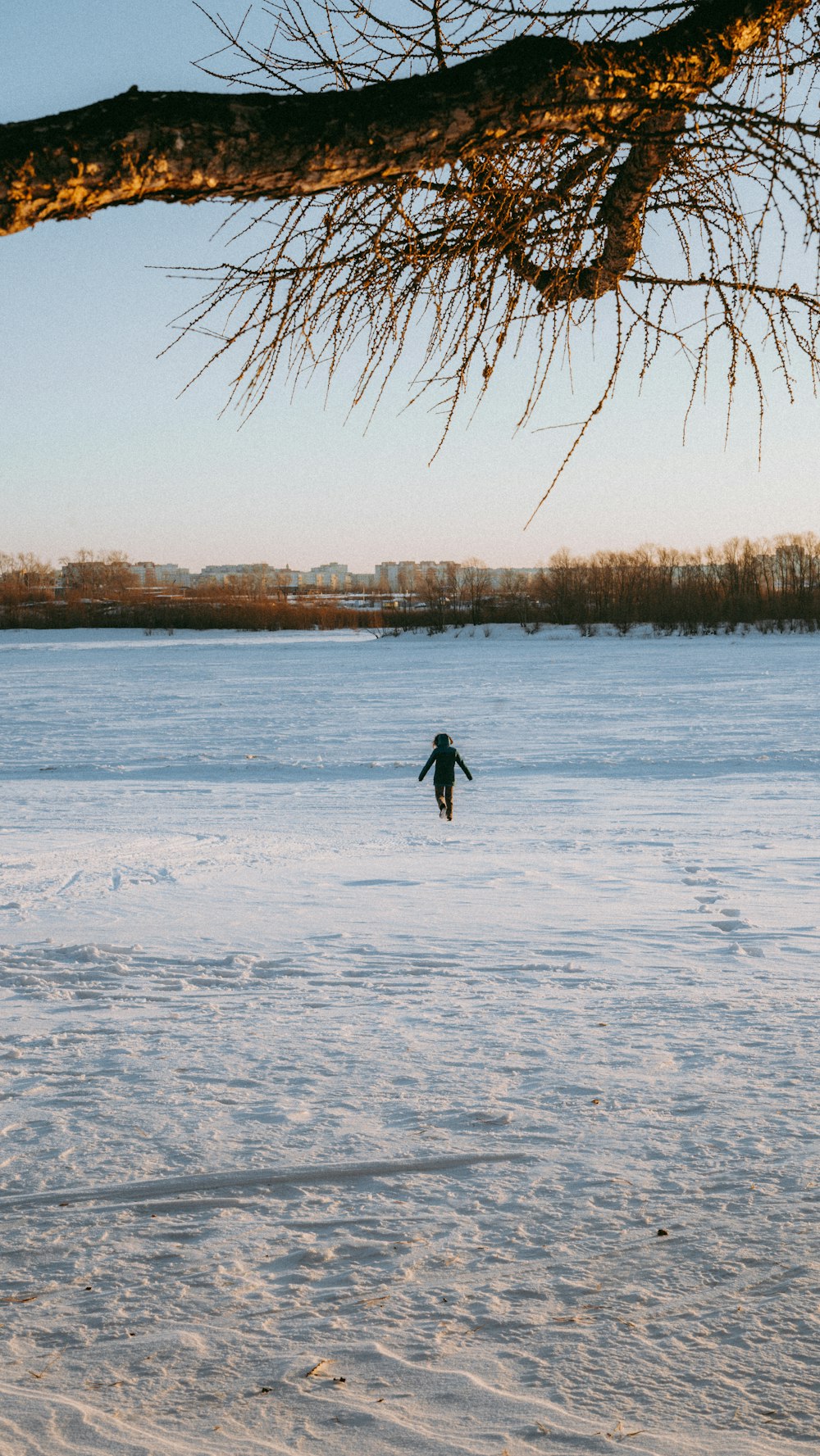 a person walking across a snow covered field